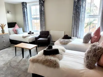 a living room with two beds and a couch at Carvetii - ANNE House Room 3 - Triple bed first flr en-suite in Carlisle