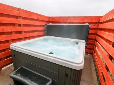 a jacuzzi tub sitting in a brick wall at The Barn @ Clauchan holiday Cottages in Gatehouse of Fleet