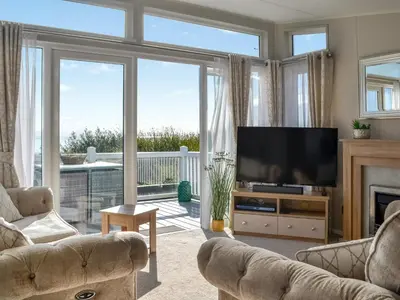 a living room with a television and a fireplace at Gill Bay - Uk45513 in Mainsriddle