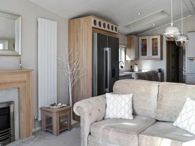 a living room with a couch and a fireplace at Gill Bay - Uk45513 in Mainsriddle