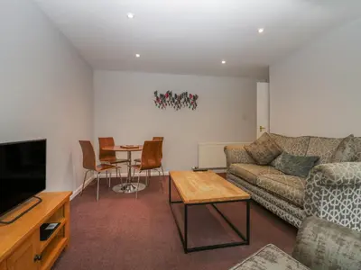 a living room with a couch and a table at Apartment 6 in Keswick