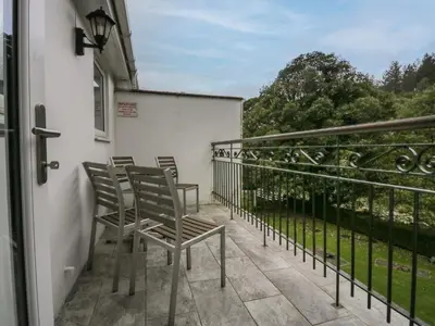a row of chairs sitting on a balcony at Apartment 6 in Keswick