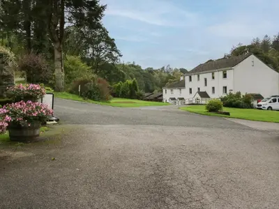 a driveway leading to a white house at Apartment 6 in Keswick