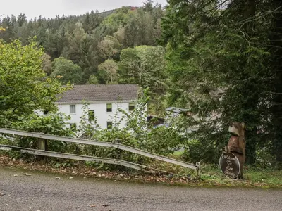 a white house with a fence in front of it at Apartment 1 in Keswick