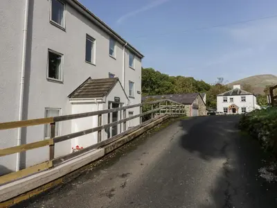 an empty road next to a white building at Apartment 3 in Keswick