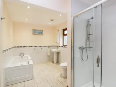 a bathroom with a shower and a sink and a toilet at Cairnhapple House in Stranraer