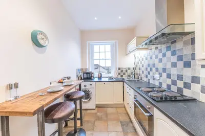 a kitchen with a sink and a stove top oven at Town centre property convenient for the fells in Keswick