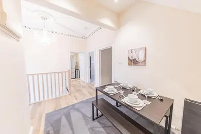 a dining room with white walls and a table at Town centre property convenient for the fells in Keswick