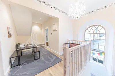 a dining room with a table and a chandelier at Town centre property convenient for the fells in Keswick