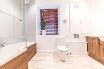 a bathroom with a toilet and a tub and a sink at Town centre property convenient for the fells in Keswick