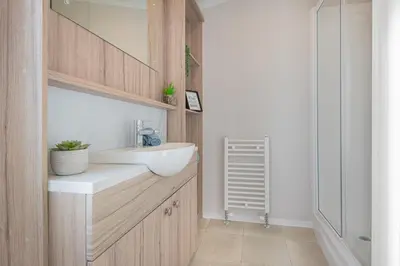 a bathroom with a sink and a mirror at Birch Timber Holiday Lodge in Bassenthwaite