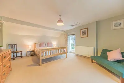 a bedroom with a bed and a couch at Historic St Bees Farmhouse Hot Tub Games Summer Gatherings in St Bees