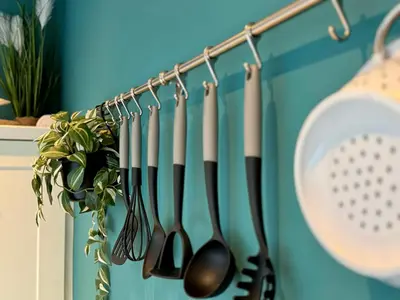 a bunch of utensils hanging on a rack at Chestnut Cottage in Dalmellington