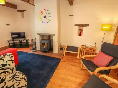 a living room with a couch and a fireplace at Beck Edge in Keswick