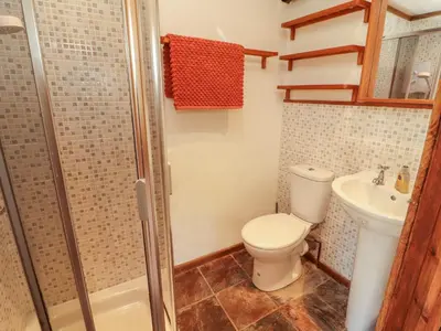a bathroom with a toilet and a sink and a shower at Beck Edge in Keswick