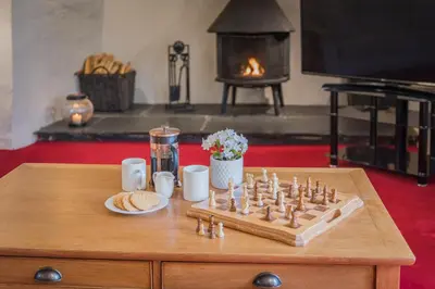 a chess game on a table in a living room at farmhouse braithwaite mews in Keswick