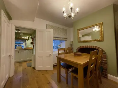 a kitchen and dining room with a table and chairs at Spa Cottage in Braithwaite