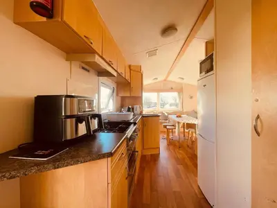 a kitchen with a stove and a refrigerator at Newton Stewart-Sleeps 6-Pool-Parking-Pet Friendly in Newton Stewart