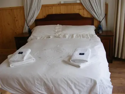 a white bed with towels on top of it at Trevelyan Hotel in Douglas