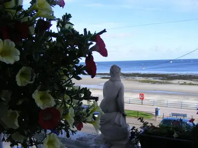 a statue of a woman looking out at the beach at Trevelyan Hotel in Douglas