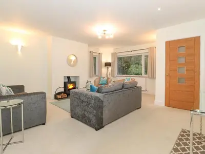 a living room with two couches and a fireplace at Tandarra in Keswick