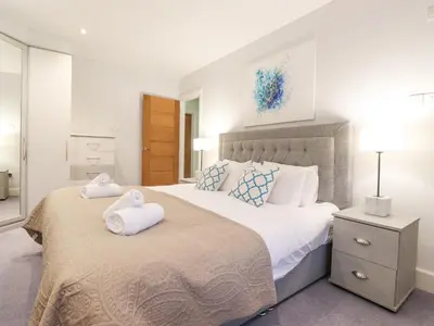 a bedroom with a large bed with two towels on it at Tandarra in Keswick