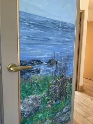 a painting of the ocean through a door at The Hutchinson Apartments in Douglas