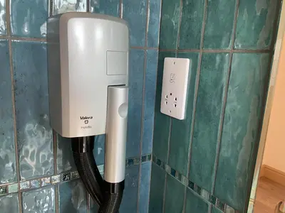 a phone and a cord hooked up to a wall at The Hutchinson Apartments in Douglas