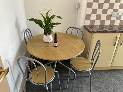 a table with two bottles of wine and a plant on it at The Hutchinson Apartments in Douglas