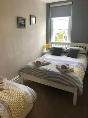 a bedroom with two beds with towels on them at Fell Top View - Fantastic Keswick Centre apartment in Keswick