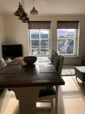a dining room table with a bowl on top of it at Fell Top View - Fantastic Keswick Centre apartment in Keswick