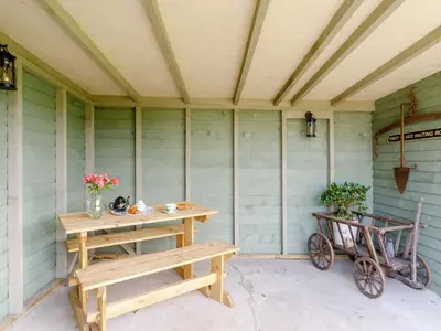 a porch with a bench and a table and a cart at 1 Bed in Easton 56742 in Kirklinton