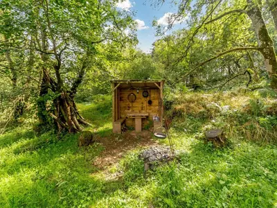 a wooden bird house in the middle of a field at 1 Bed in Easton 56742 in Kirklinton