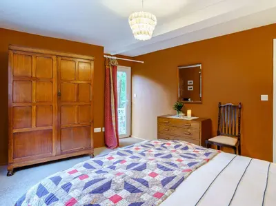 a bedroom with a bed and a dresser and a window at 2 Bed in Cockermouth 86528 in Arlecdon