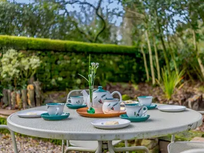 a white table with cups and saucers on it at 2 Bed in Cockermouth 86528 in Arlecdon