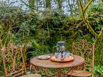 a table with two mugs and a coffee pot on it at 2 Bed in Cockermouth 86528 in Arlecdon