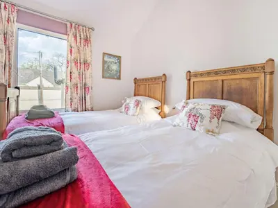two beds sitting next to each other in a bedroom at 2 bed in Keswick 87732 in Keswick