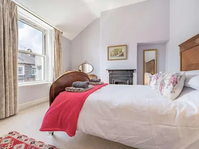 a bedroom with a bed with a red blanket on it at 2 bed in Keswick 87732 in Keswick