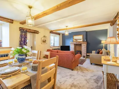 a living room with a table and a couch at 3 Bed in Bridekirk 85717 in Bridekirk