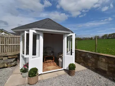 a white gazebo with a black roof at 3 Bed in Bridekirk 85717 in Bridekirk
