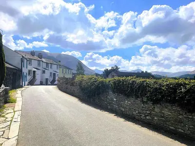 a street with houses and a stone wall at 2 Bed in High Lorton 86023 in Lorton