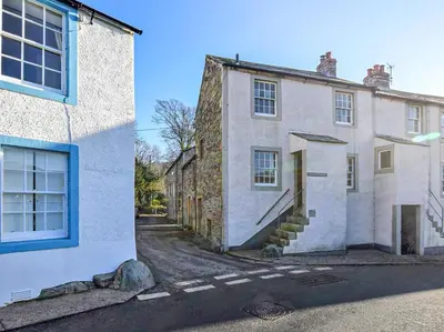 an old stone house with blue windows on a street at 2 Bed in High Lorton 86023 in Lorton