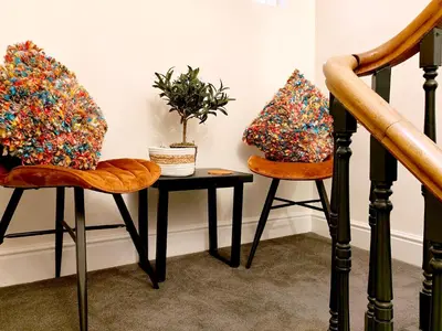 two chairs and a table with a plant on it at Cranford House in Keswick