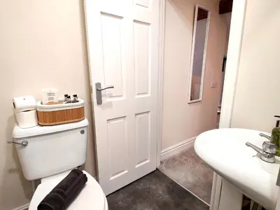 a bathroom with a toilet and a sink at Cranford House in Keswick