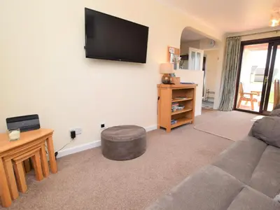 a living room with a couch and a flat screen tv at 2 Bed in Isle of Whithorn 77880 in Isle of Whithorn