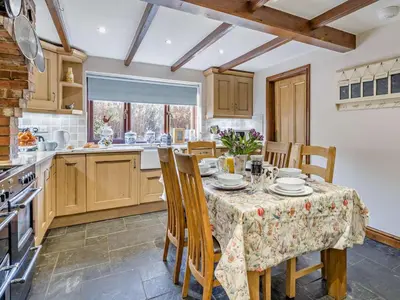 a kitchen with a table and chairs and a kitchen with a stove at 5 Bed in Cleator oc-sz529 in Ennerdale Bridge