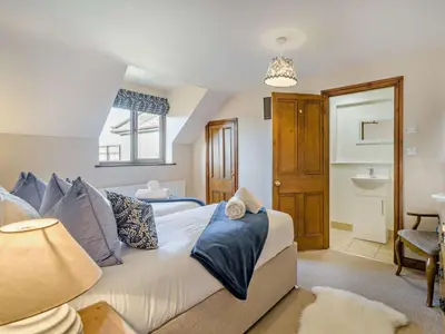 a bedroom with a large bed with blue pillows at 5 Bed in Cleator oc-sz529 in Ennerdale Bridge