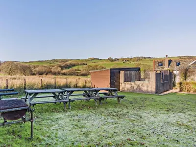 a picnic table and a grill in a field at 5 Bed in Cleator oc-sz529 in Ennerdale Bridge