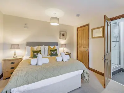 a bedroom with a large bed with white pillows at 5 Bed in Cleator oc-sz529 in Ennerdale Bridge