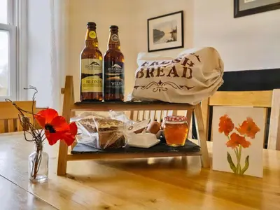 a table with two bottles of beer and a bag at 3 Bed in Ennerdale Bridge SZ392 in Ennerdale Bridge